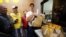 A McDonald's employee passes orders to Glovo food delivery couriers inside a restaurant, after the chain reopened amid Russia's ongoing invasion of Ukraine, in Kyiv, Ukraine, Sept. 20, 2022. 