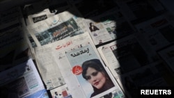 A newspaper with a cover picture of Mahsa Amini, a woman who died after being arrested by the Islamic republic's 'morality police' is seen in Tehran, Sept. 18, 2022. (Majid Asgaripour/West Asia News Agency)