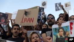 Protesters shout slogans during a protest against the death of Iranian Mahsa Amini, at central Syntagma square, in Athens, Greece, Saturday, Sept. 24, 2022.