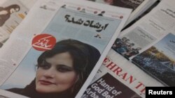A newspaper with a cover picture of Mahsa Amini, a woman who died after being arrested by Iranian police is seen in Tehran, Iran, Sept. 18, 2022. (West Asia News Agency via Reuters)