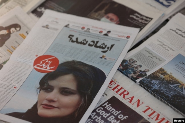 A newspaper with a cover picture of Mahsa Amini, a woman who died after being arrested by Iranian morality police is seen in Tehran, Iran, Sept. 18, 2022. (West Asia News Agency via Reuters)