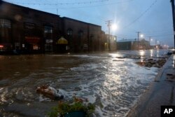 Water rushes down Front Street, just a half block from the Bering Sea, in Nome, Alaska, on Saturday, Sept. 17, 2022.
