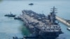 Kapal induk AS USS Ronald Reagan dikawal saat tiba di Busan, Korea Selatan, Jumat, 23 September 2022. (Foto: AP)