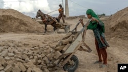 FILE - A 12-year-old Afghan girl works in a brick factory on the outskirts of Kabul, Afghanistan, Aug. 17, 2022.