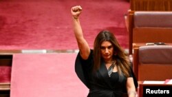 FILE - Indigenous Australian parliamentarian Lidia Thorpe raises her fist during her swearing-in ceremony in the Senate chamber at Parliament House in Canberra, Australia, Aug. 1, 2022. 