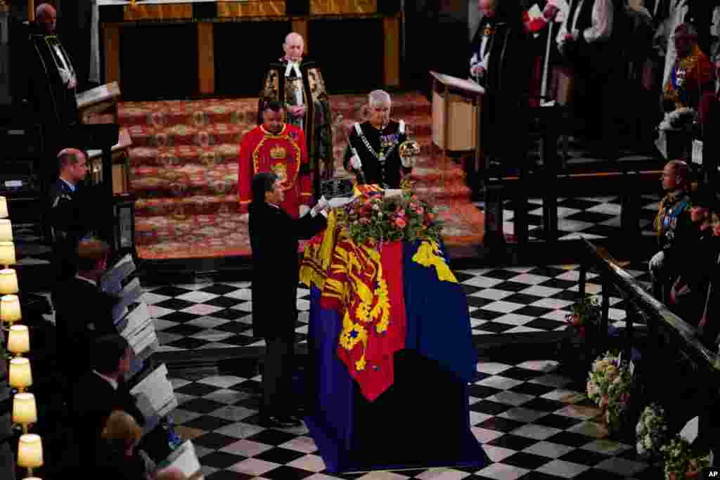 The Imperial State Crown is removed from the coffin during the Committal Service for Queen Elizabeth at St. George&#39;s Chapel, at Windsor Castle, Sept. 19, 2022.
