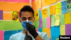 FILE - Dr. Mayank Amin draws the Moderna coronavirus disease booster vaccine targeting BA.4 and BA.5 omicron subvariants at Skippack Pharmacy in Schwenksville, Pennsylvania, Sept. 8, 2022.