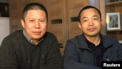 An undated handout photo shows Ding Jiaxi and Xu Zhiyong (L) pictured together in Guangzhou before their arrests in late 2019 and early 2020 respectively.