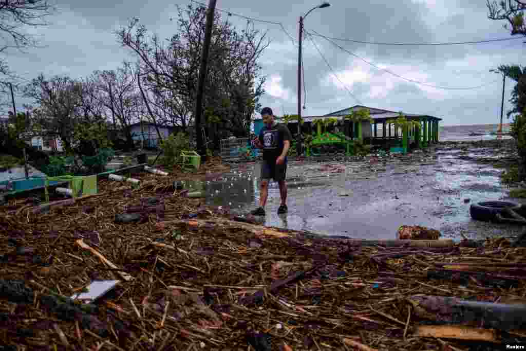 A man walks through debris in the aftermath of Hurricane Fiona in Guayanilla, Puerto Rico, Sept. 19, 2022.