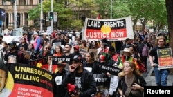 Indigenous Australians and supporters march through the city center to "abolish the monarchy" on the country's national day of mourning for Britain's Queen Elizabeth, in Sydney, Sept. 22, 2022.