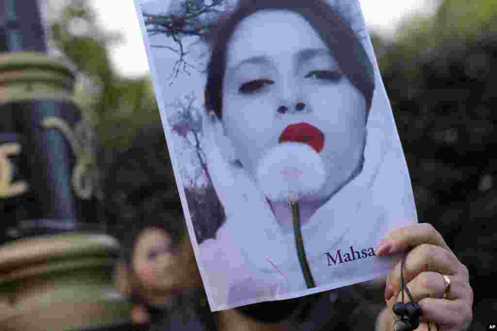Demonstrators hold placards outside the Iranian Embassy in London on Sept. 25, 2022, to protest the death of Mahsa Amini.