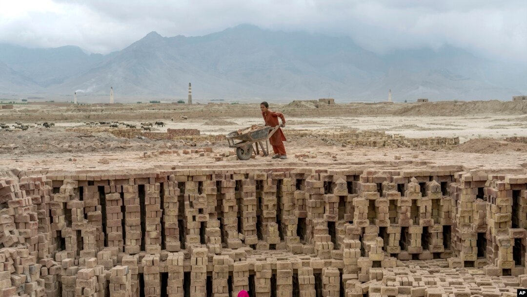 Afghan children work in a brick factory on the outskirts of Kabul, Afghanistan, July 23, 2022.
