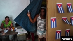 A voter walks out of a booth at a polling station during the new Family Code referendum in Havana, Cuba, Sept. 25, 2022. 