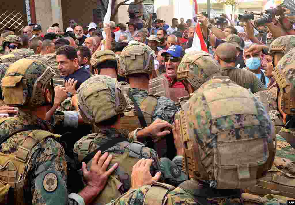 Lebanese army soldiers clash with retired military personnel as they try to break into the parliament in Beirut, during a session to approve the 2022 budget.&nbsp;The protesters were demanding an increase in their monthly retirement pay, decimated during the economic meltdown.
