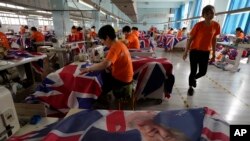 Workers produce British flags at the Shaoxing Chuangdong Tour Articles Co factory in Shaoxing, in eastern China's Zhejiang province, Sept. 16, 2022.