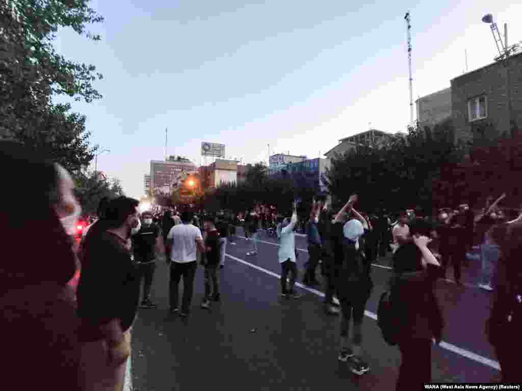 People attend a protest over the death of Mahsa Amini, a woman who died after being arrested by the Islamic republic's "morality police", in Tehran, Iran, Sept. 21, 2022. 