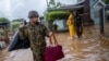 Members of the Puerto Rico National Guard rescue a woman who had been stranded in Hurricane Fiona in Salinas, Puerto Rico, Sept. 19, 2022. 