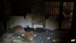 Duvets and sleeping bag are seen in a basement which, according to Ukrainian authorities, was used as a torture cell during the Russian occupation, in the retaken village of Kozacha Lopan, Ukraine, Sept. 17, 2022. 