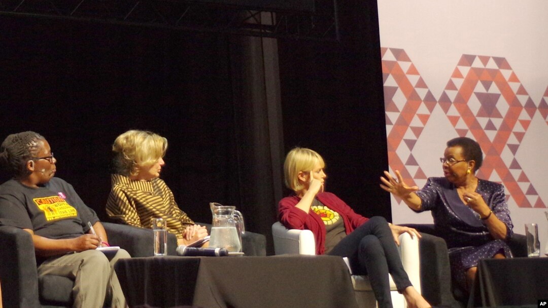 Graca Machel, right, wife of former President Nelson Mandela, makes a point about the rights of young adolescent women as actress Charlize Theron looks on at the 2016 AIDS Conference in Durban, South Africa, July 19, 2016. 