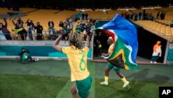 South African players celebrate as they hold the national after the Women's World Cup Group G soccer match between South Africa and Italy in Wellington, New Zealand, Wednesday, Aug. 2, 2023.