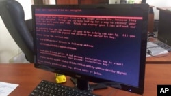 A computer screen cyberattack warning notice reportedly holding computer files to ransom, as part of a massive international cyberattack, at an office in Kiev, Ukraine, Tuesday June 27, 2017, A new and highly virulent outbreak of malicious data-scrambling software appears to be causing mass disruption across Europe, hitting Ukraine especially hard.