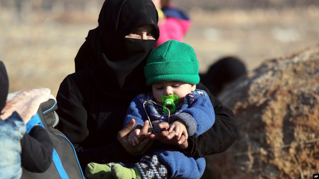 A Syrian woman and a child, evacuated from the city of Aleppo arrive at a refugee camp in Rashidin, near Idlib, Syria, Dec. 19, 2016. A plan, so far opposed by Damascus, envisions the creation of civilian safe zones in northern parts of Syria.