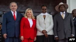 Ugandan President Yoweri Museveni, right, and Uganda's First Lady Janet Museveni, 2nd from right, pose for a photo with Israeli Prime Minister Benjamin Netanyahu, left, and his wife Sara Netanyahu, at the State House in Entebbe, Uganda on Feb. 3, 2020.