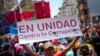 ARCHIVO - Un simpatizante del gobierno sostiene un cartel con un mensaje que dice en español: "En unidad contra la corrupción", durante un mitin contra la corrupción, en Caracas, Venezuela, el sábado 25 de marzo de 2023.