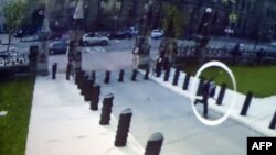 A close circuit video image shown during an Oct. 23, 2014 press conference at Royal Canadian Mounted Police headquarters in Ottawa shows supected shooter Michael Zehaf-Bibeau (circled) running towards the Canadian Parliament.