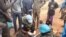 FILE - A person receives help as locals gather at a UN peacekeeper camp following deadly attacks, in Dokura, Abyei region, Sudan-South Sudan border area, in this still image obtained from a social media video released January 28, 2024.