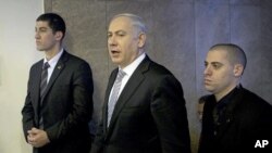 Israel's Prime Minister Benjamin Netanyahu, center, arrives at the weekly cabinet meeting in Jerusalem, February 5, 2012.