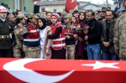 People react by the coffin for Emin Yildirim, one of the 33 Turkish soldiers killed on Thursday in a Syrian army attack in the Idlib region of Syria, at his funeral in Hatay, Turkey, Feb. 29, 2020.