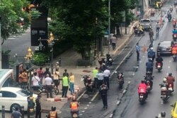 A crowd gathers near the site where explosions were heard in Bangkok, Thailand, Aug. 2, 2019, in this image obtained via social media. (Twitter/@YRNMXSK)