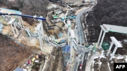 TOPSHOT - Rescue members search for missing workers after a bridge collapsed at an expressway construction site in Anseong on Feb. 25, 2025.