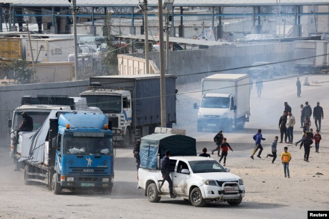 FILE - Trucks carrying aid arrive, amid the ongoing conflict between Israel and the Palestinian Islamist group Hamas, in Rafah in the southern Gaza Strip, Jan. 17, 2024.