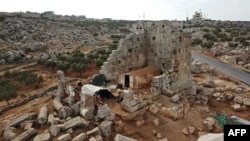 FILE - A makeshift camp of displaced Syrians is seen on Nov. 1, 2020, at Byzantine ruins in a region of northwest Syria called the Dead Cities.