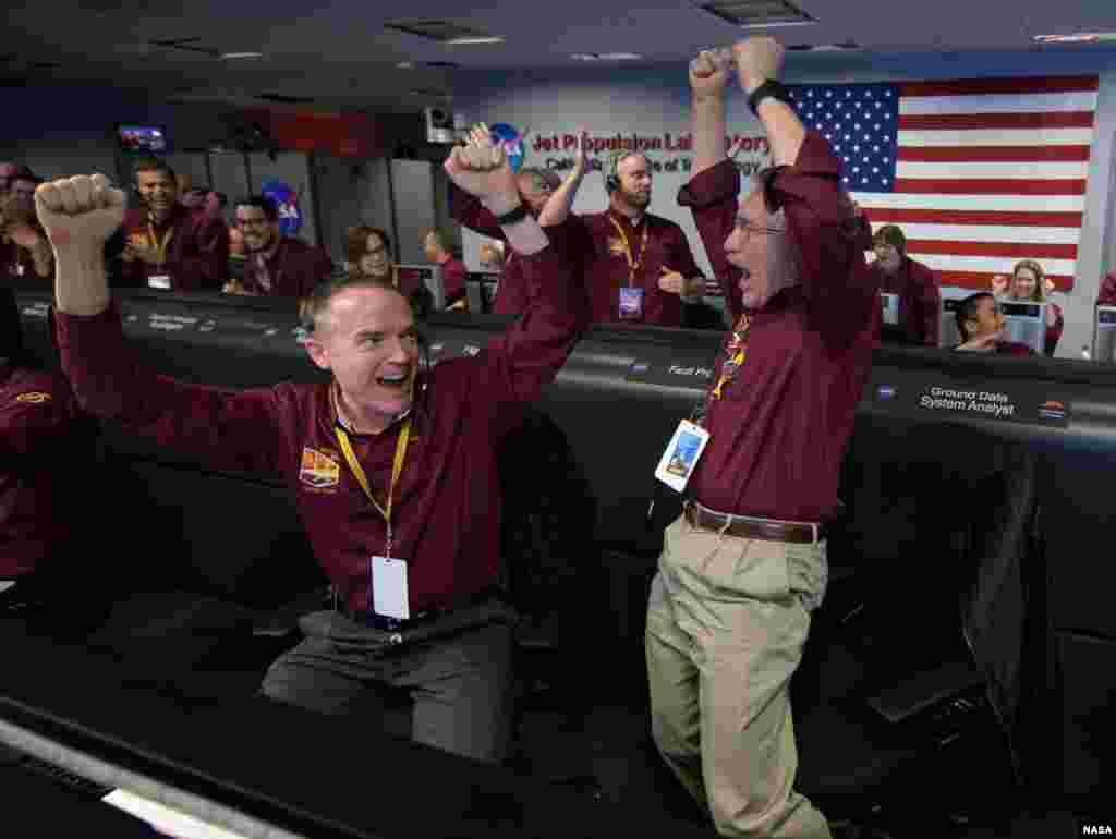 Mars InSight team members Kris Bruvold, left, and Sandy Krasner react after receiving confirmation that the Mars InSight lander successfully touched down on the surface of Mars, Nov. 26, 2018 inside the Mission Support Area at NASA&#39;s Jet Propulsion Laboratory in Pasadena, California. InSight, short for Interior Exploration using Seismic Investigations, Geodesy and Heat Transport, is a Mars lander designed to study the &quot;inner space&quot; of Mars: its crust, mantle, and core.