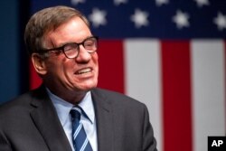 FILE - Sen. Mark Warner, D-Va., addresses the news media in Alexandria, Va., Nov. 3, 2020.