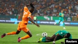 Ivory Coast's Odilon Kossounou challenges Senegal's Ismaila Sarr for the ball during the 2023 Africa Cup of Nations Round of 16 match held at Charles Konan Banny Stadium, Yamoussoukro, Ivory Coast, January 29, 2024.