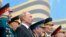FILE - Flanked by World War II veterans, Russian President Vladimir Putin watches a military parade marking 74 years since the end of World War II, in Red Square, in Moscow, Russia, May 9, 2019.
