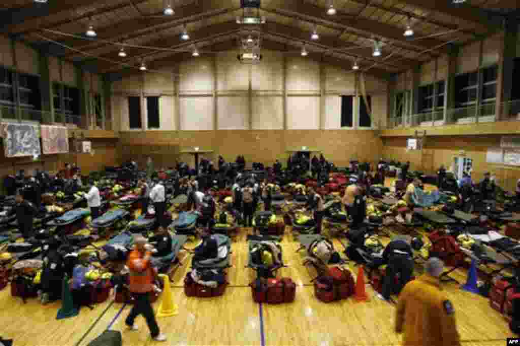 U.S. and British search and rescue teams set up a base to bed in for the night in a gymnasium after arriving at the Setamai school in Sumita, northern Japan, Monday, March 14, 2011. Two search and rescue teams from Fairfax County, Virginia, and Los Angele