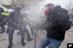 FILE - Rioters loyal to President Donald Trump at the U.S. Capitol on Jan. 6, 2021, in Washington. Liberal groups are trying to end Trump's attempt to return to the White House by arguing that he is no longer eligible to be president after trying to overturn the 2020 election results.