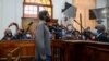 Zandile Christmas Mafe, a suspect accused of breaking into Parliament when the fire started, appears in the Cape Town Magistrate Court, in Cape Town, South Africa, Jan. 4, 2022. 