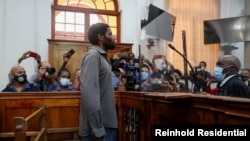 Zandile Christmas Mafe, a suspect accused of breaking into Parliament when the fire started, appears in the Cape Town Magistrate Court, in Cape Town, South Africa, Jan. 4, 2022. 