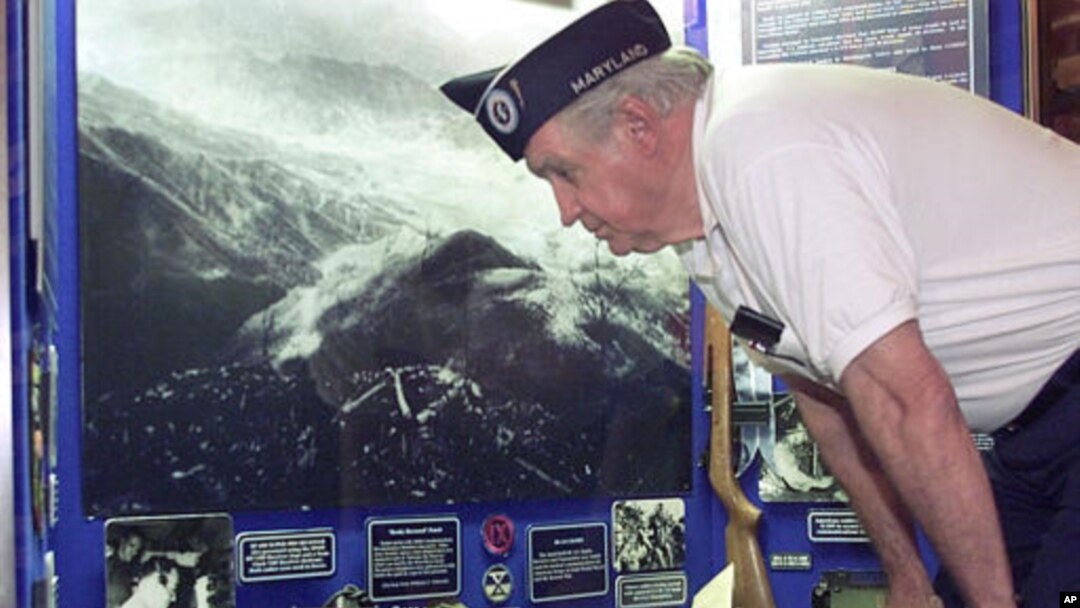 Raymond Glock of Dundalk, Md., who was a U.S. Army sergeant with the 40th Infantry Division during the Korean War, looks at a display explaining how cryptology was used to intercept North Korean radio transmissions during the Korean War at the National Cr