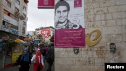 A banner depicting Mohammed Assaf, a contestant in the TV talent show 'Arab Idol', is seen on a building in the West Bank city of Ramallah May 13, 2013.