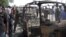 Residents survey vehicles damaged after a bomb blast at a primary school in Maiduguri, the capital of Nigeria's Borno state, February 29, 2012. 