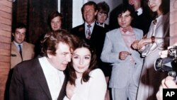 FILE - In this 1970 file photo, British actor Albert Finney embraces his bride, French Actress Anouk Aimee, after their registry office wedding in London. 