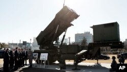 FILE - U.S. Vice President Mike Pence inspects the Patriot Advanced Capability-3 (PAC-3) missile launch system with Itsunori Onodera, Japan's defense minister, during a demonstration at the Ministry of Defense in Tokyo, Japan, Feb. 7, 2018. 