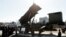 FILE - U.S. Vice President Mike Pence inspects the Patriot Advanced Capability-3 (PAC-3) missile launch system with Itsunori Onodera, Japan's defense minister, during a demonstration at the Ministry of Defense in Tokyo, Japan, Feb. 7, 2018. 